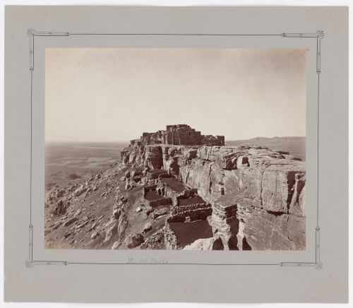 Distant view of Walpi on First Mesa showing stone structures (used as sheep and goat pens) in the foreground, Hopi Reservation, Arizona, United States