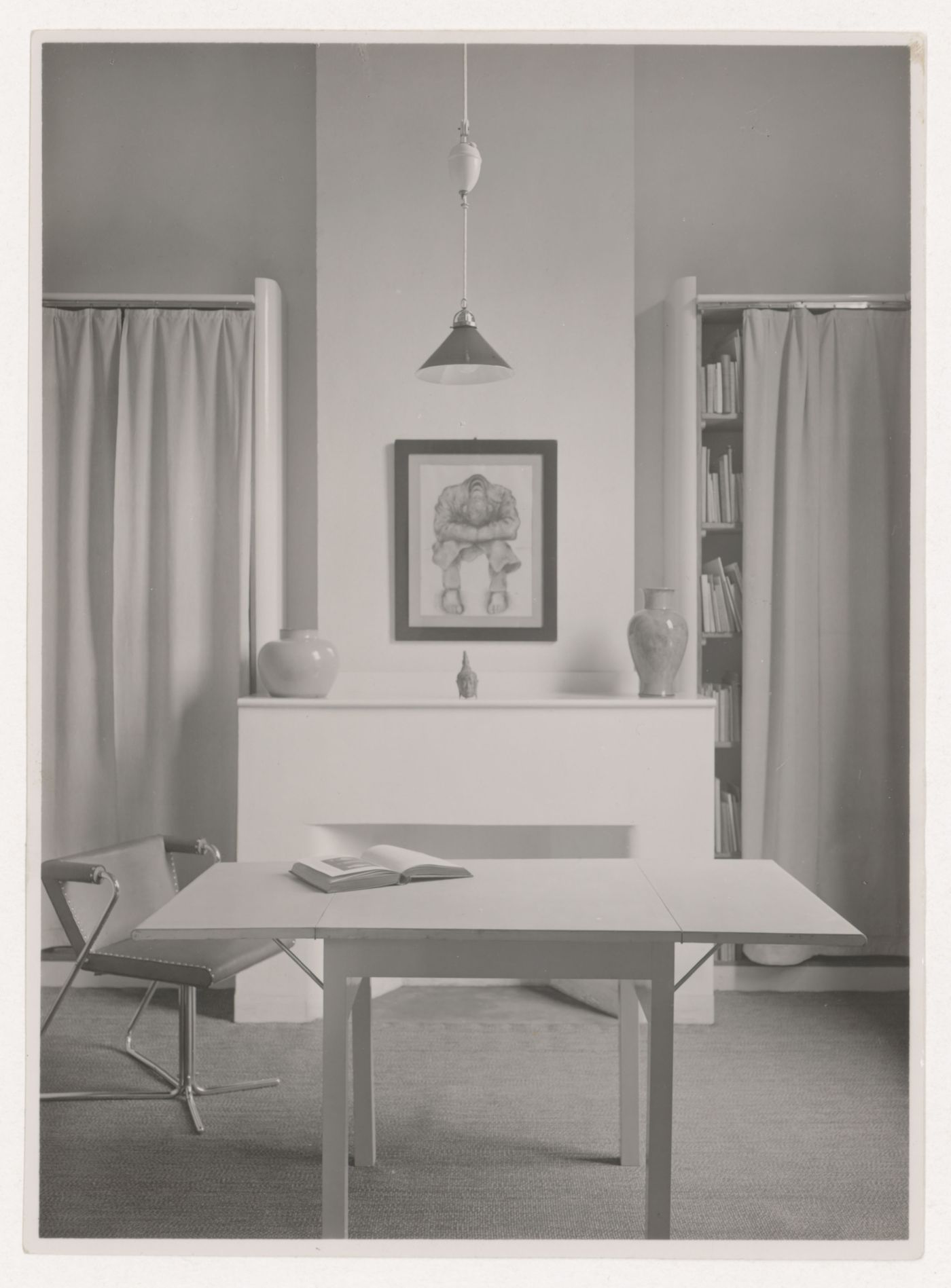Interior view of the study of Hannema House I showing an elbow chair designed by J.J.P. Oud, a dropleaf table and curtained bookshelves, Rotterdam, Netherlands