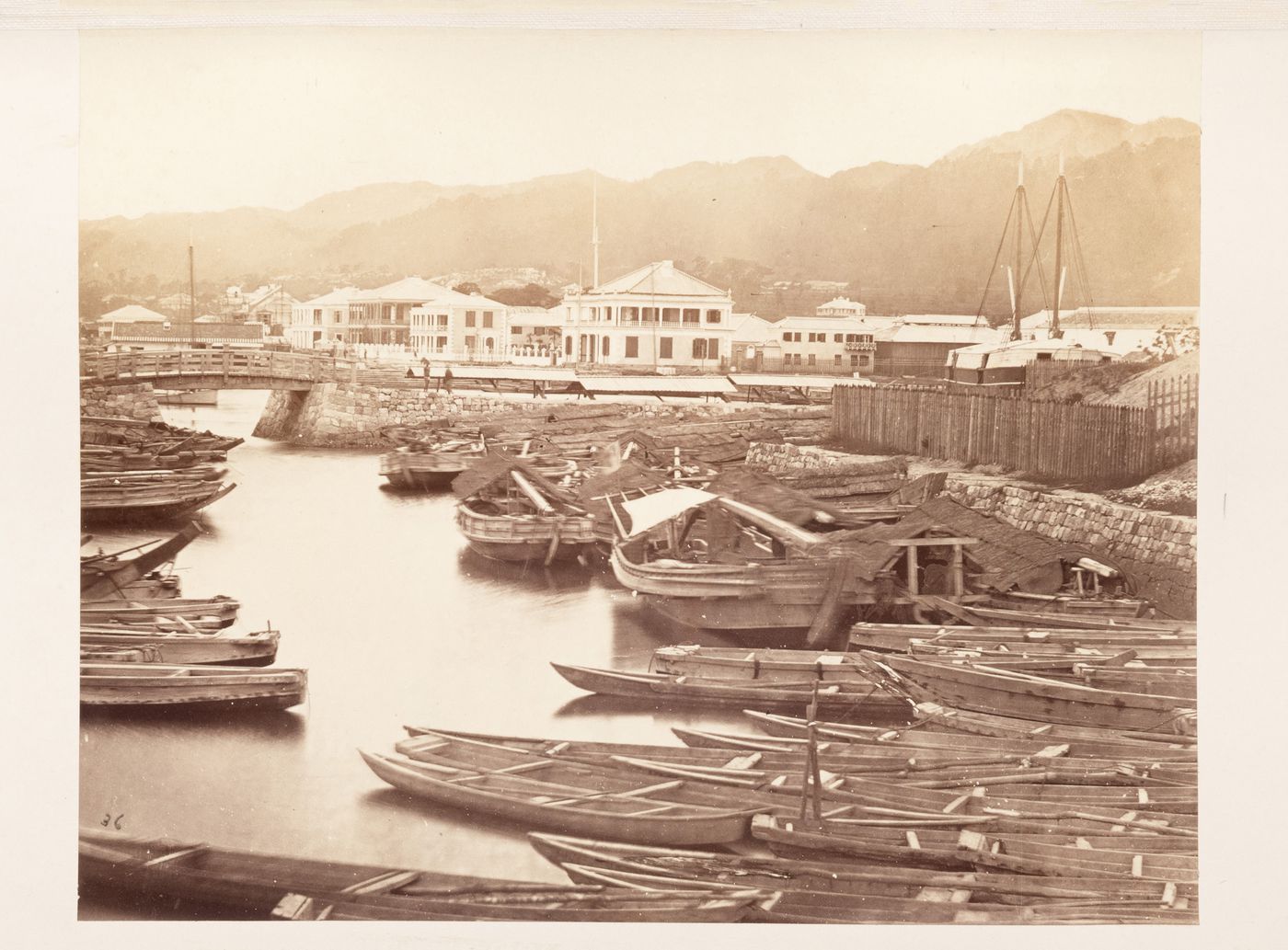 View of buildings, boats and a bridge in the foreign settlement, Kobe, Japan