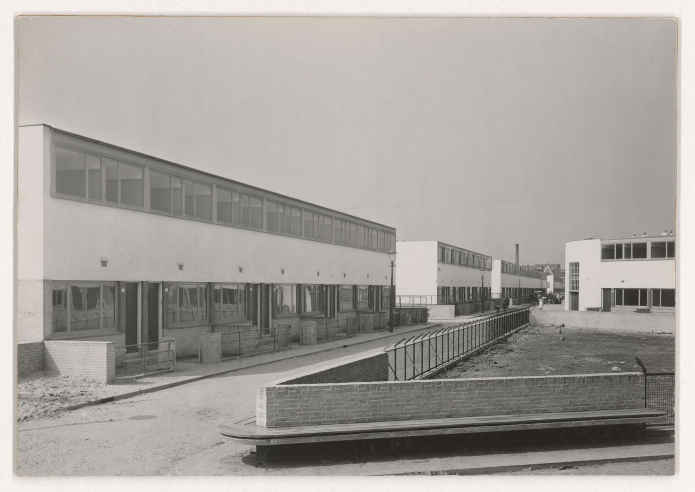 View of the principal façade of Kiefhoek Housing Estate showing a playground under construction, Rotterdam, Netherlands