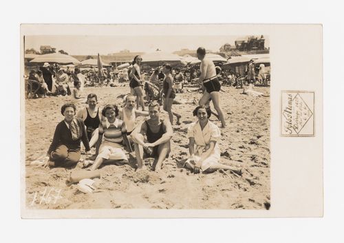 Photograph of Amancio Wiliams and unidentified people sitting at the beach