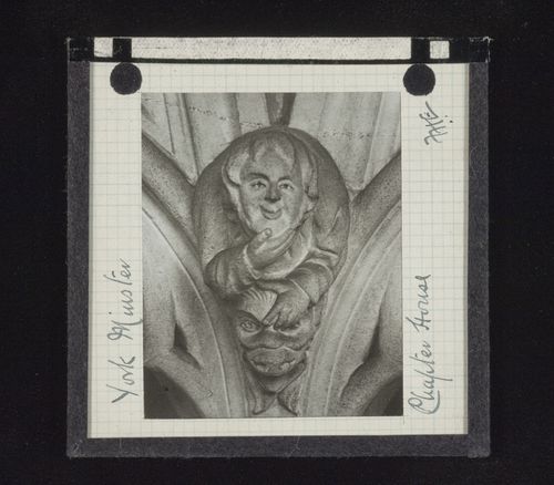 View of sculpture of man on head of grotesque figure in Chapter House of York Minster, York, North Yorkshire, England