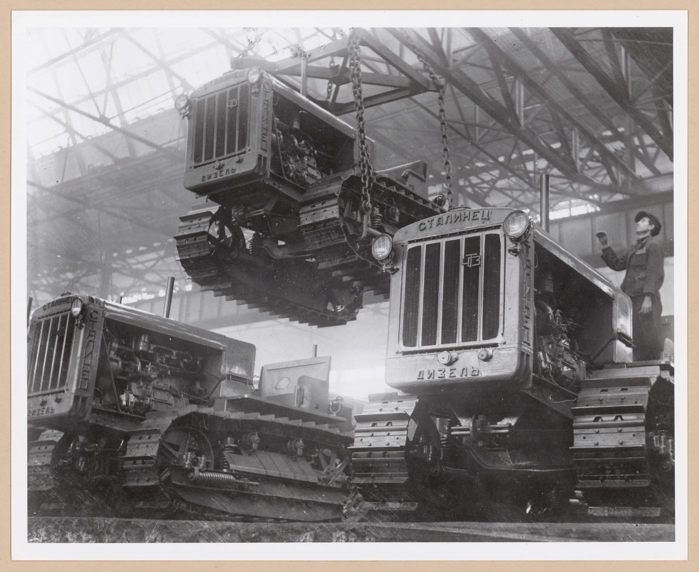 Interior view of the Assembly [?] Building showing tractors, Soviet Diesel Tractor Assembly Plant, Cheliabinsk, Soviet Union (now in Russia)