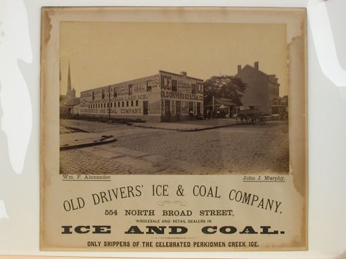 View of two-storey office building with narative murals and signage on front and side elevation, Philadelphia, Pennsylvania