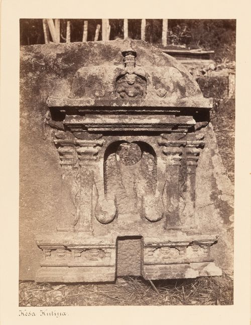 Close-up view of a stele showing bas-reliefs, including of the Buddha's footprints, with columns in the background, Anuradhapura, Ceylon (now Sri Lanka)