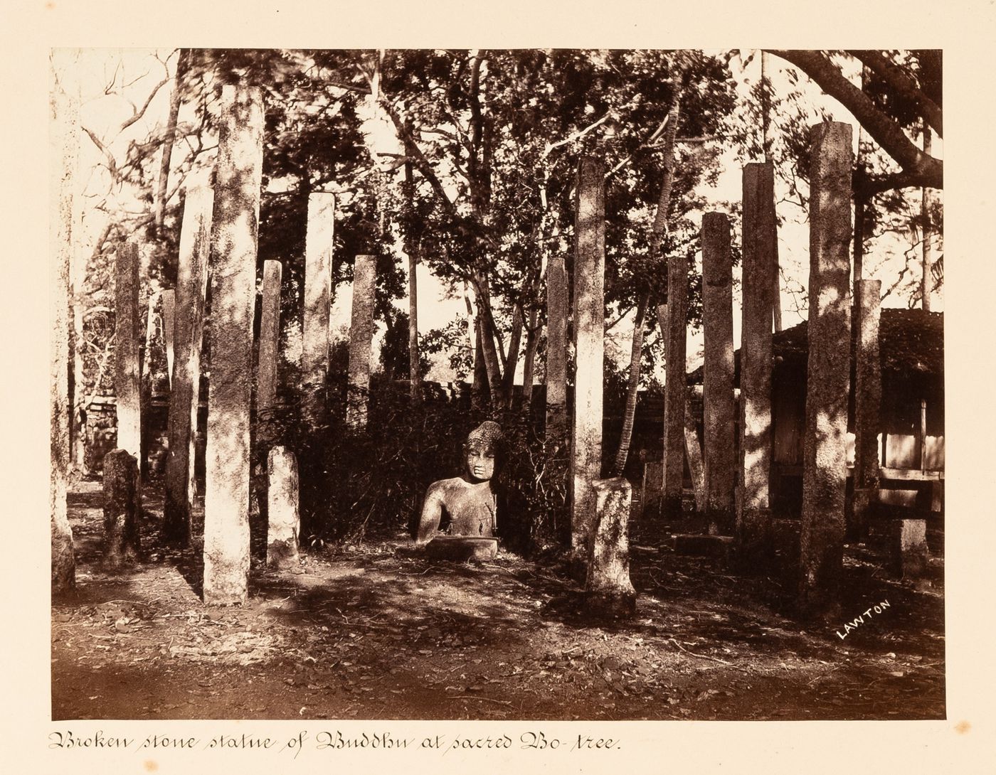 View of a statue of Buddha surrounded by columns, Bodhi Tree (also known as the Bo Tree) Enclosure, Anuradhapura, Ceylon (now Sri Lanka)