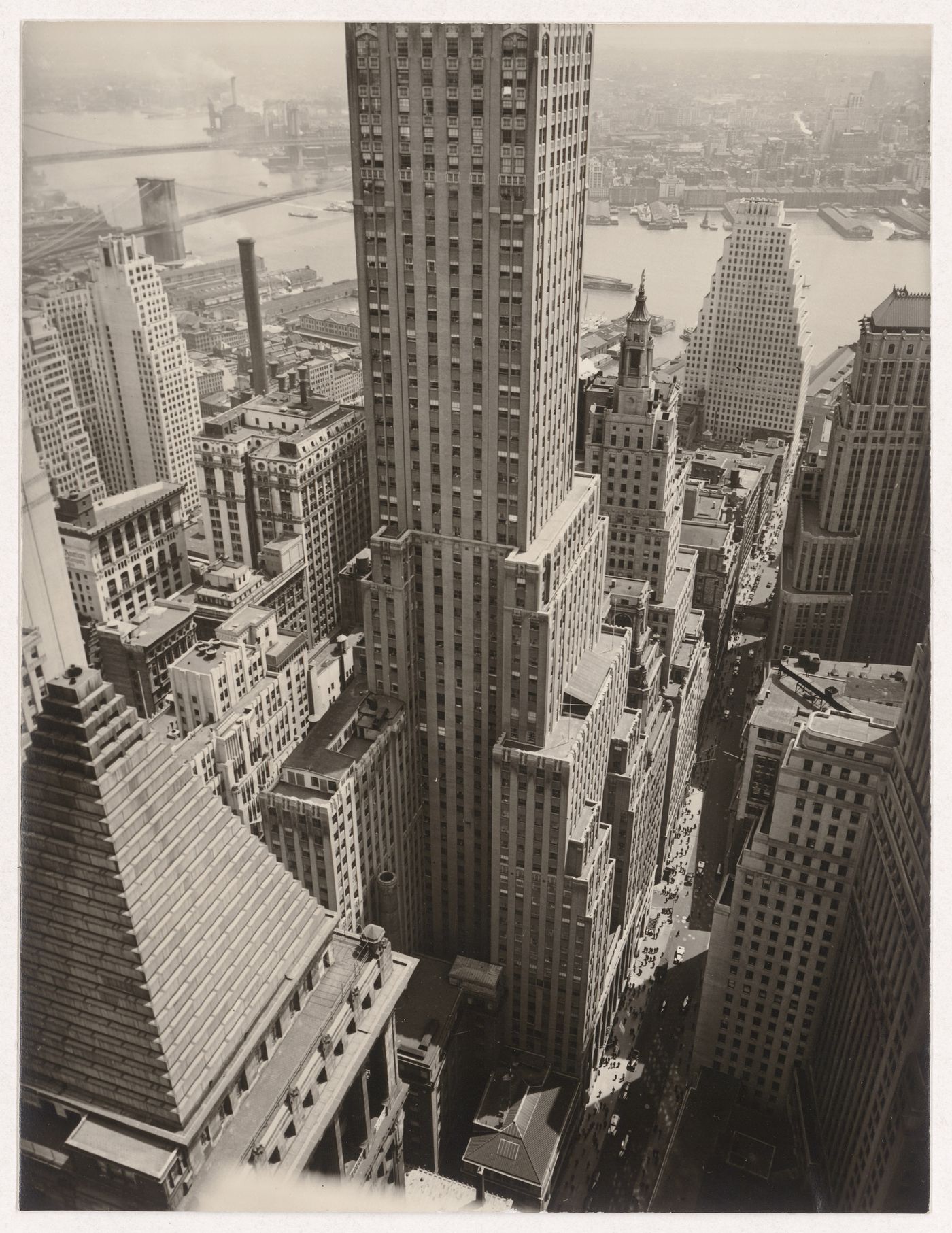 View of Wall Street showing the 40 Wall Street with the Brooklyn and Manhattan bridges in the background, from the Irvin Trust Company building, Manhattan, New York (City), New York