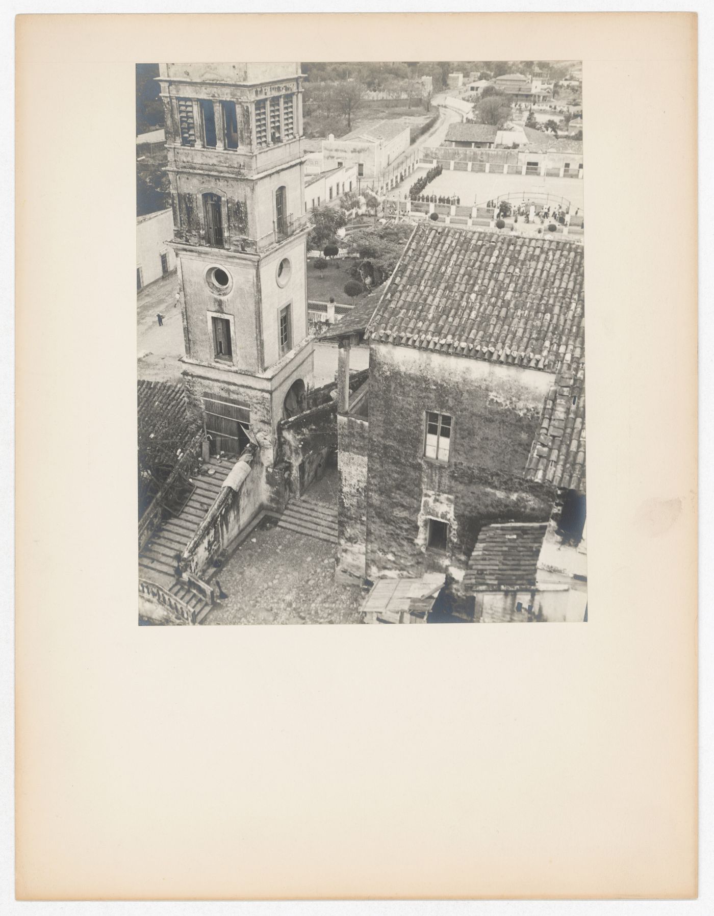 Partial view of a tower and house with an arena [?] and houses in the background, from the Catedral de Cuernavaca, Cuernavaca, Mexico