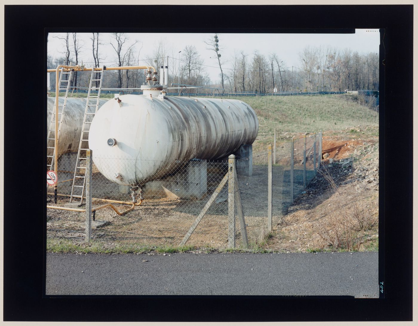 View of oil storage tanks and a fence, France