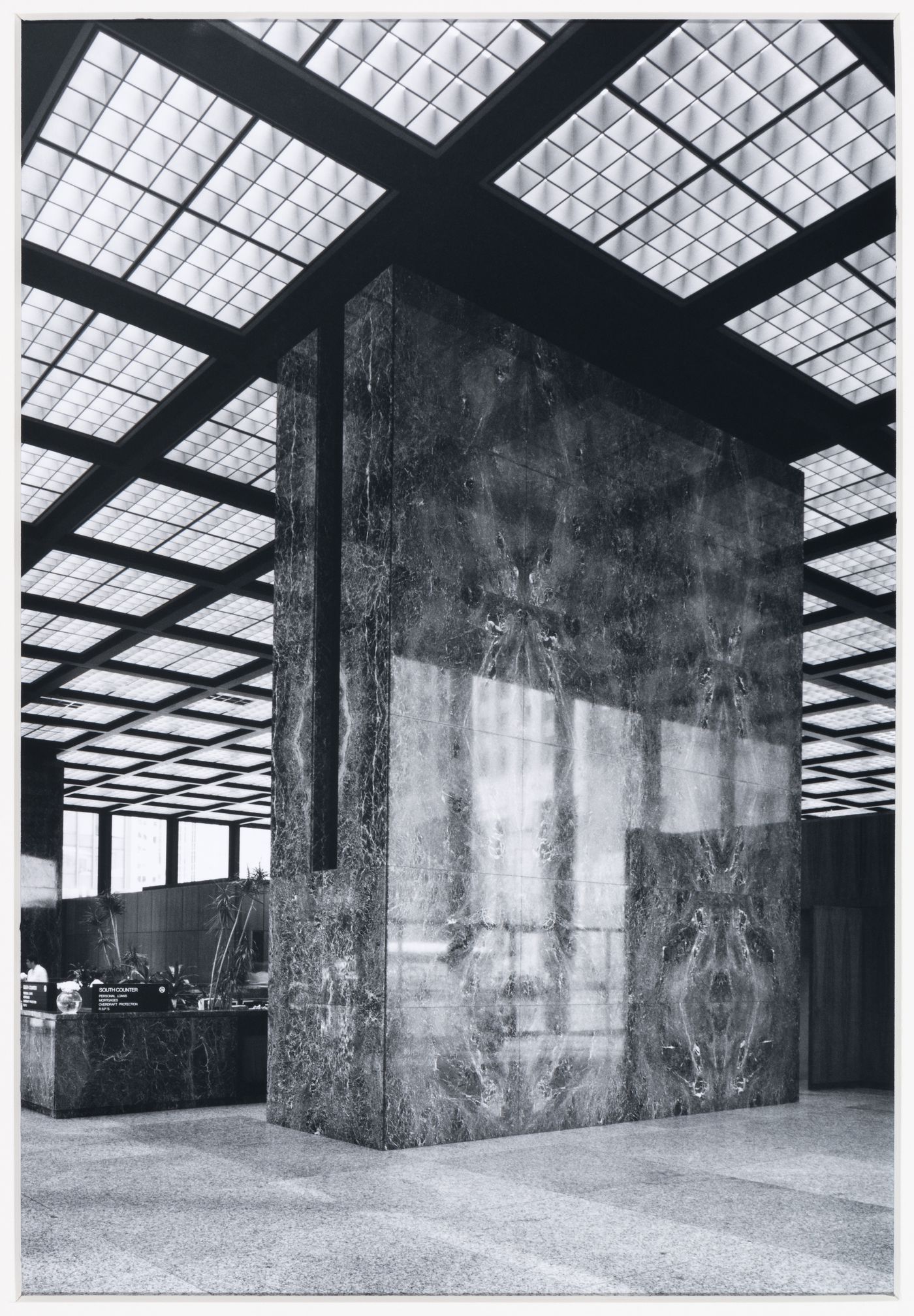 Interior view of the Toronto-Dominion Bank Pavilion showing a marble column and counter and the recessed light fixtures designed by Edison Avery Price [?], Toronto