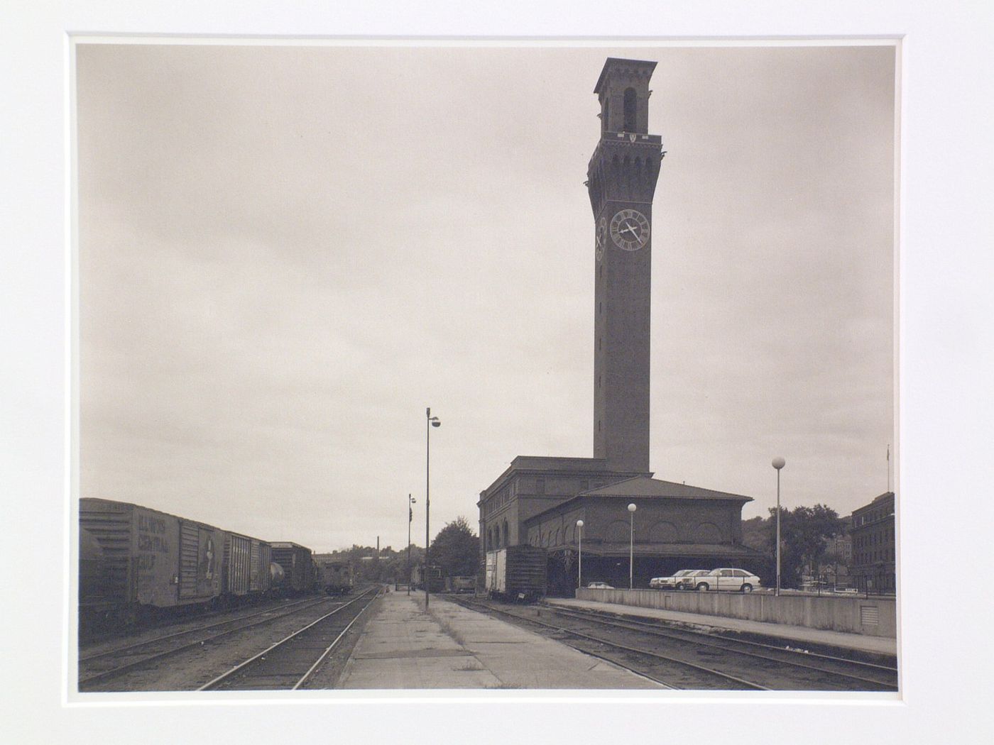 View of train depot with clocktower, trains on tracks, Waterbury, Connecticut