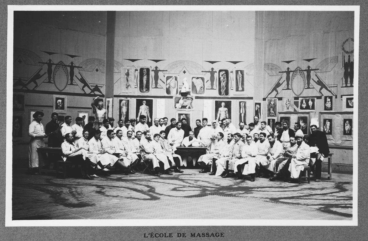View of a group of people in lab coats in front of anatomical models in the military hospital housed in the Grand Palais during World War I, Paris, France