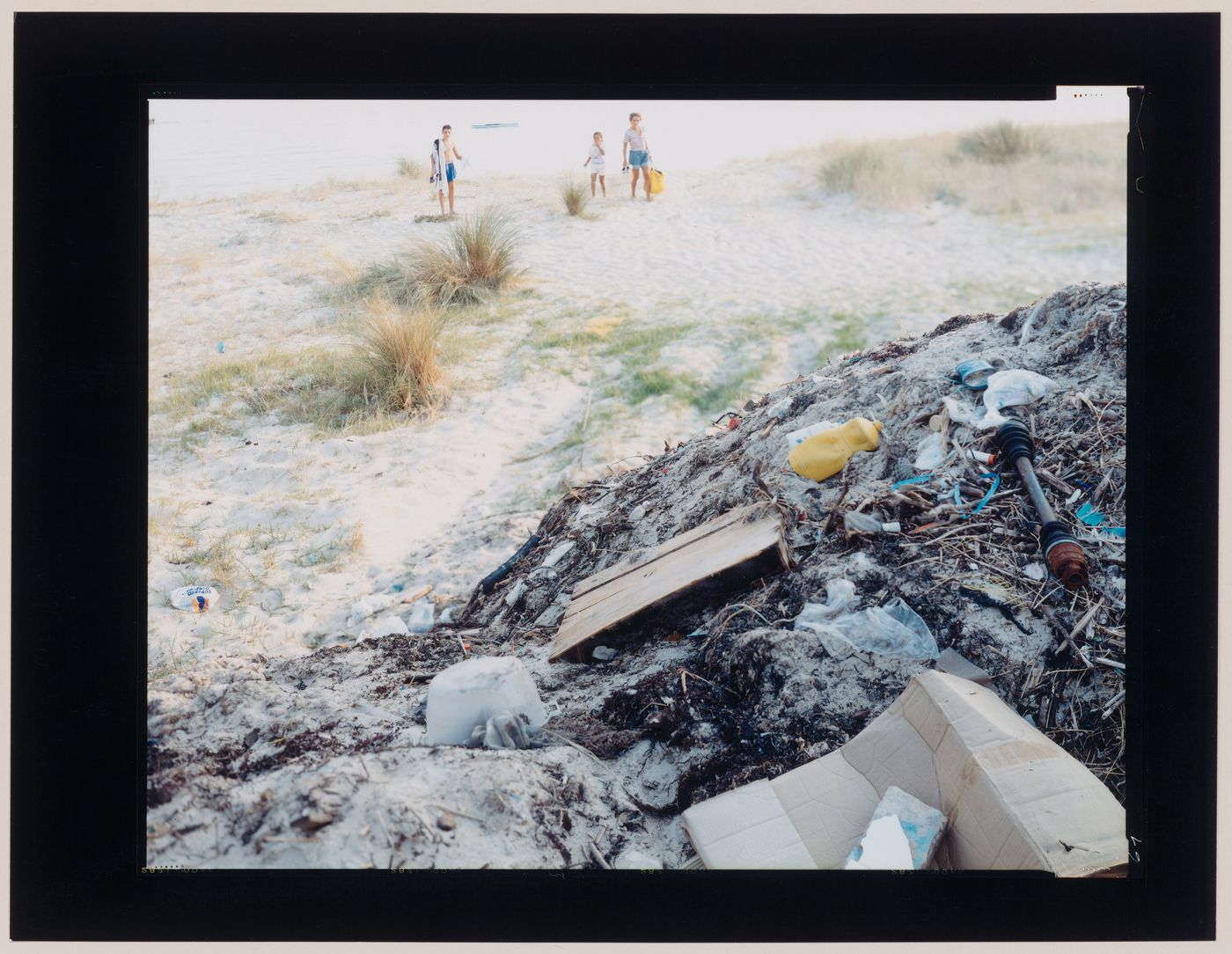 View of a pile of rubbish, a beach and a family, Cape Finisterre, Spain (from the series "In between cities")