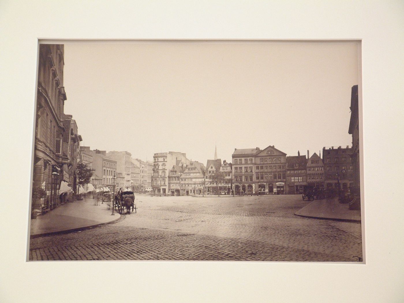 View of open square with surrounding buildings, wagons and carriages, Hamburg, Germany