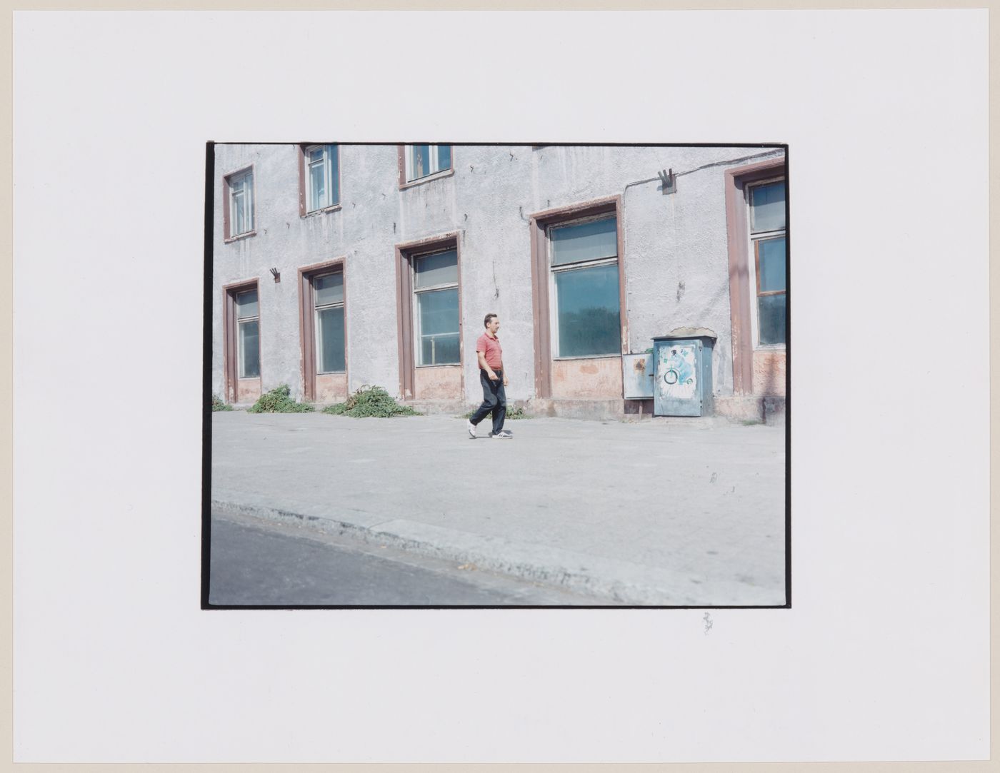 Portrait of a man walking by a building, Kaliningrad, Kaliningradskaia oblast', Russia (from the series "In between cities")