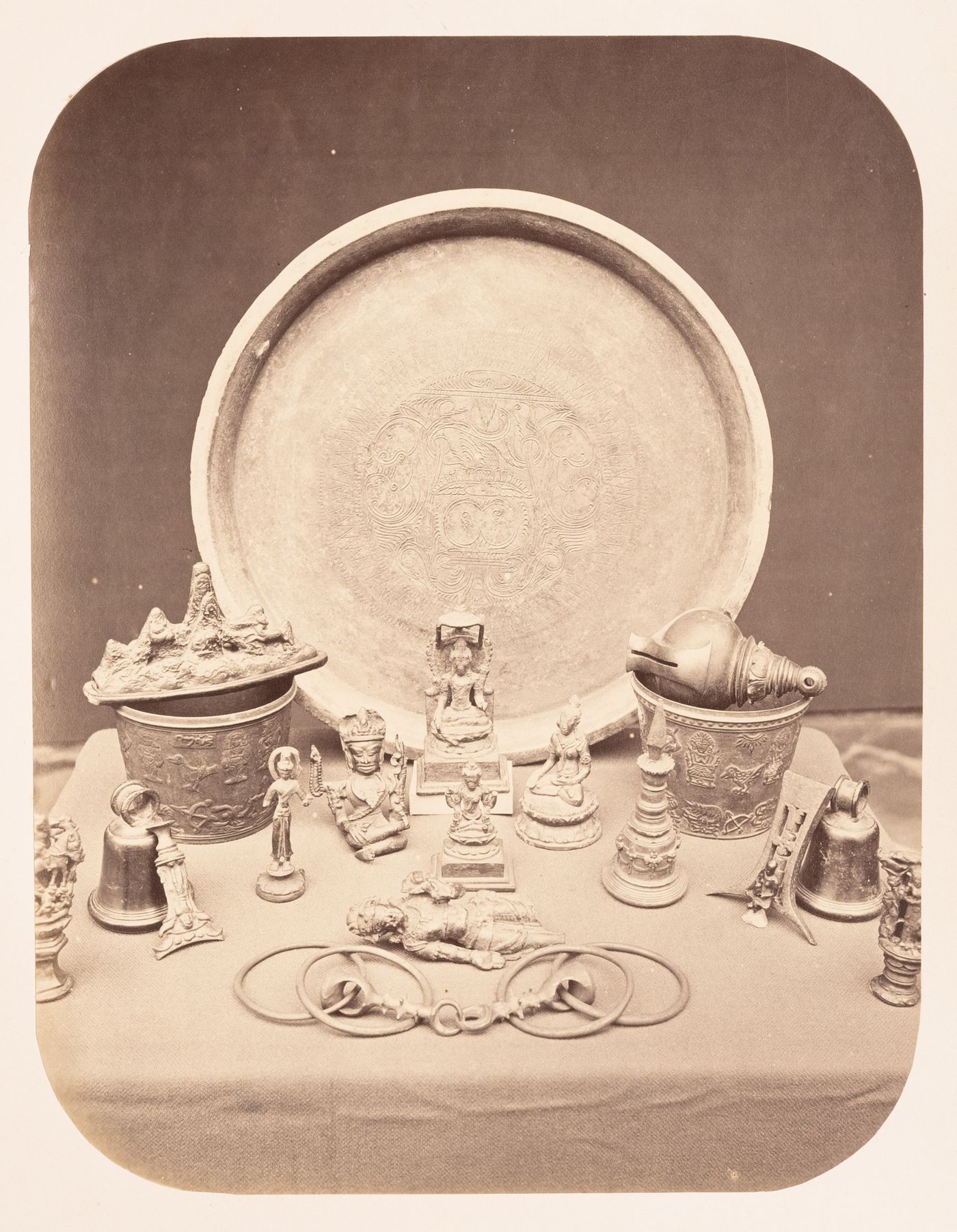 View of bronze figurines, pots, a platter and other objects, Dutch East Indies (now Indonesia)
