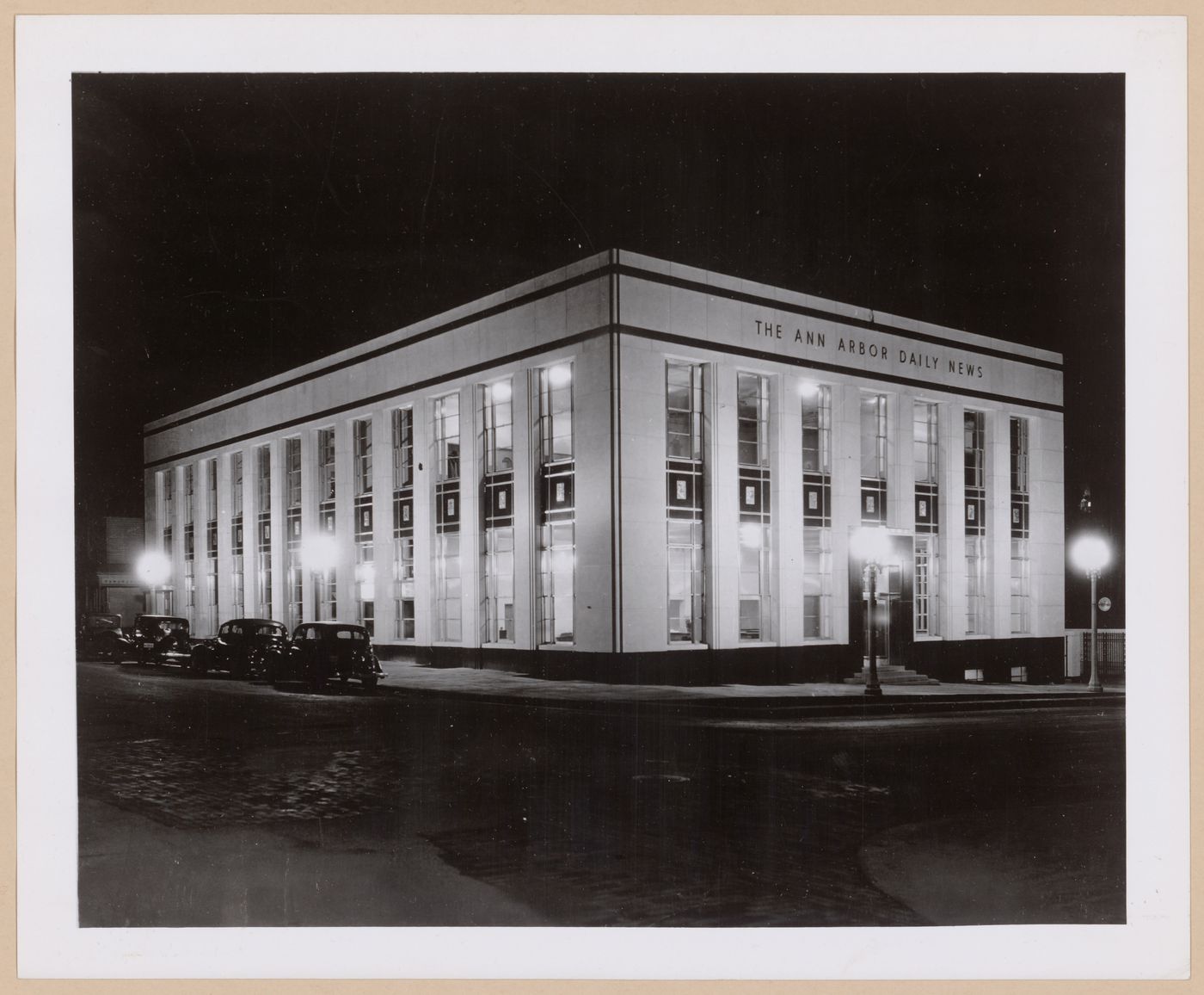 View of the principal and lateral façades of the Ann Arbour Daily News Building at night, Detroit, Michigan