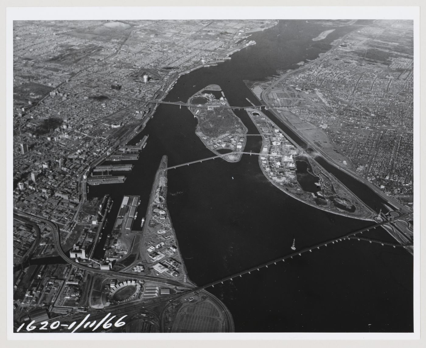 Aerial view of Montréal, of the Île Notre-Dame and Île Sainte-Hélène sites, and of the South Shore, Expo 67, Montréal, Québec