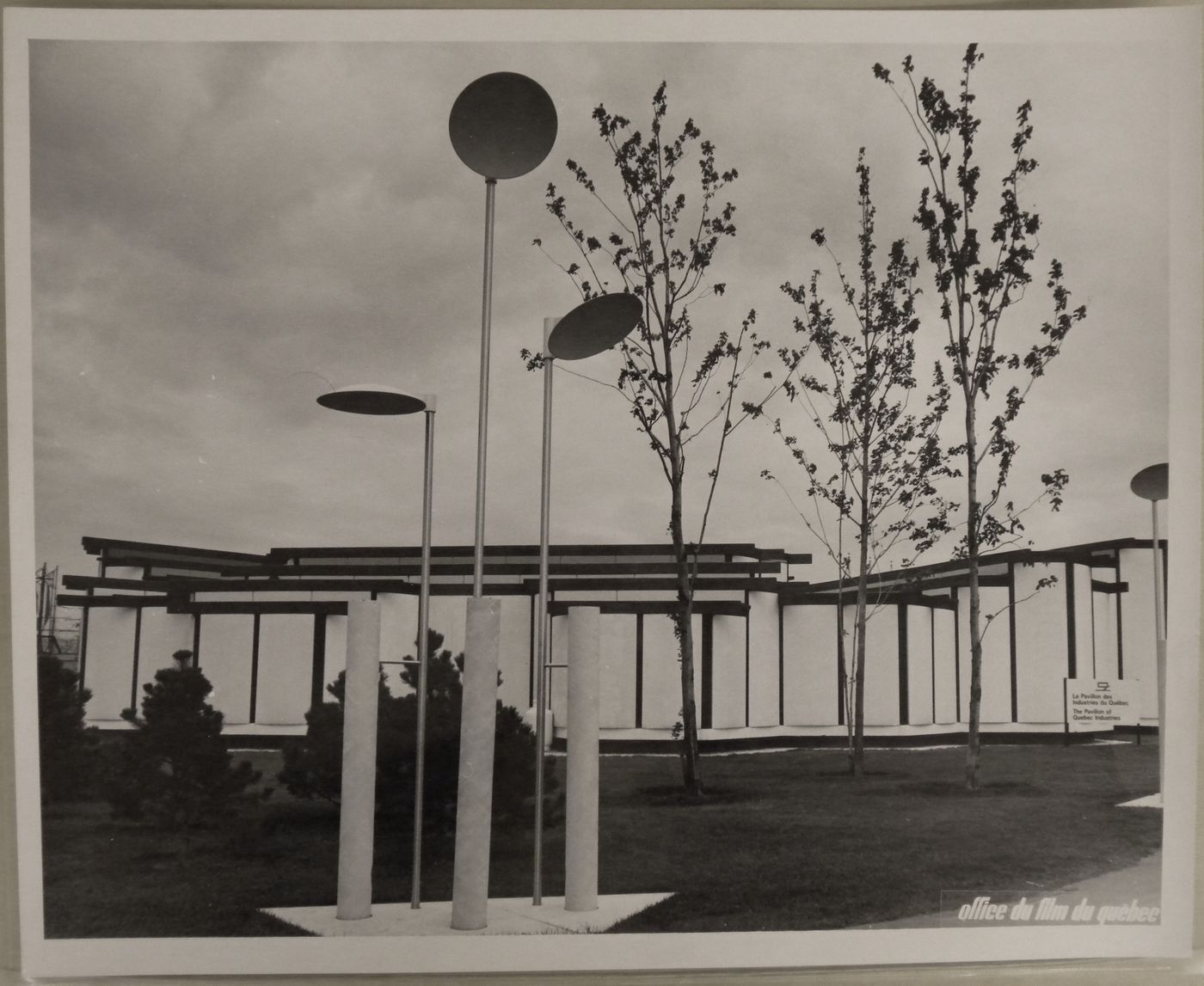 View of the exterior lighting designed by Luis F. Villa, with the Pavilion of Quebec Industries in background, Expo 67, Montréal, Québec