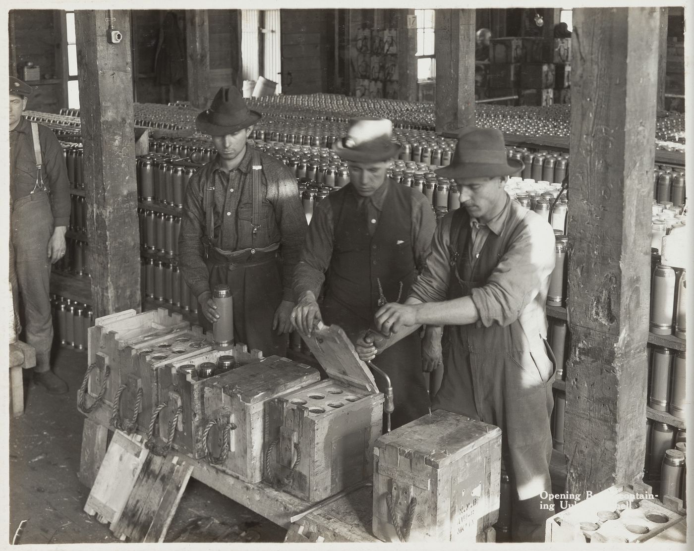 Interior view of workers opening boxes containing shells at the Energite Explosives Plant No. 3, the Shell Loading Plant, Renfrew, Ontario, Canada