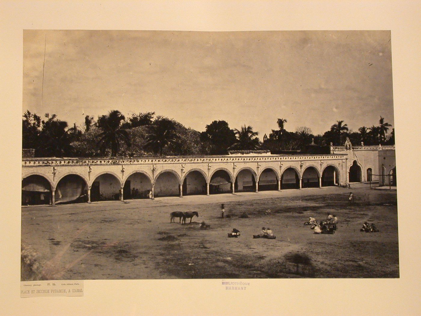 View of a plaza and arcade with the ruins of the Second Pyramid [?] in the background, Izamal, Mexico