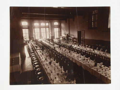 Interior view of a dining hall showing multiple tables with elaborate dinner settings, possibly in Derbyshire, England