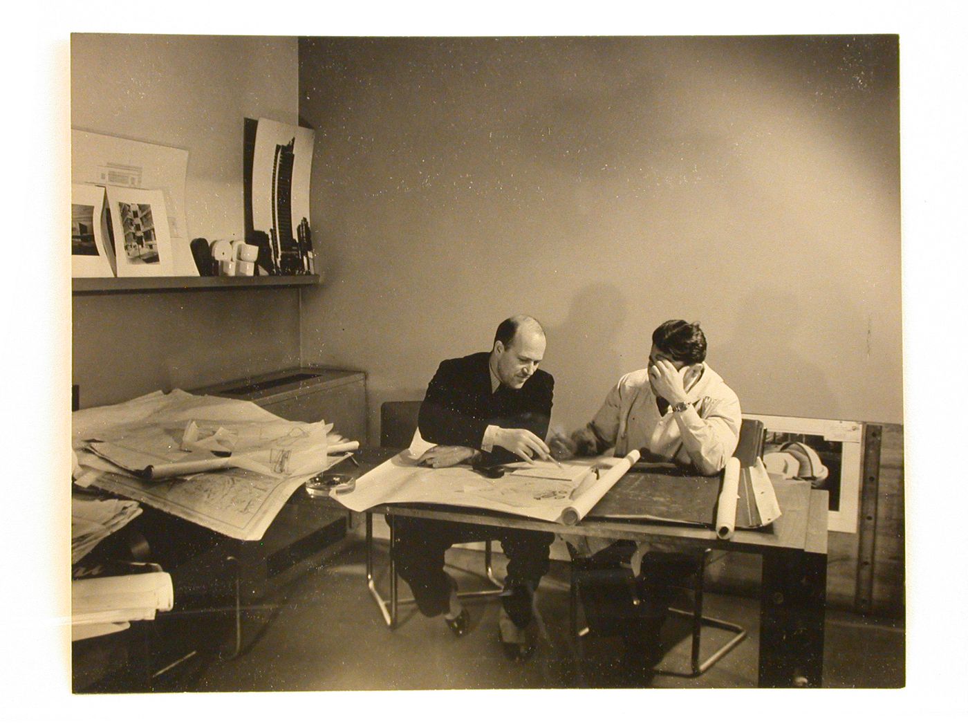 Portrait of Lescaze and another man at work with architectural plans