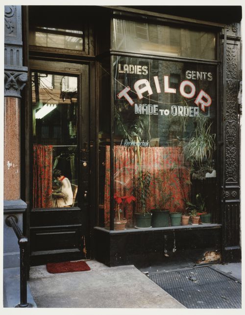 View of Tailor shop store front, with woman seated inside, East 7th Street, New York City, New York