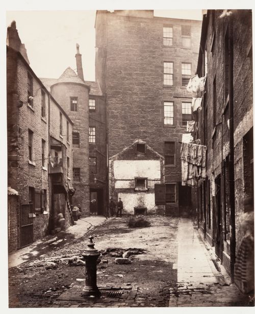 View of Closes Nos. 97 and 103 showing a common water tap or pump in the foreground, Saltmarket [street], Glasgow, Scotland
