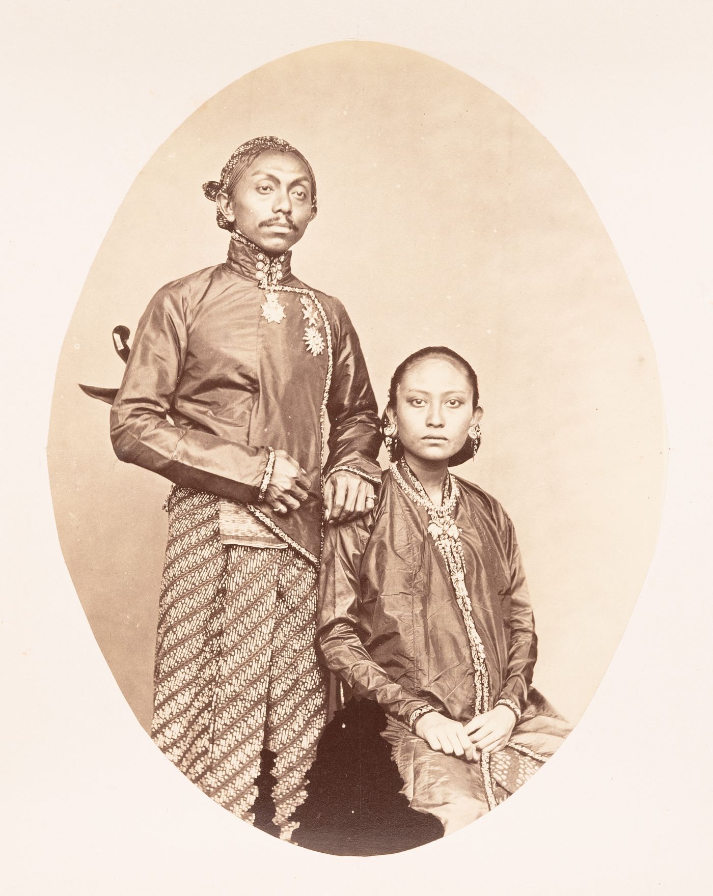 Group portrait of Sultan Paku Buwono IX, Sunan of Solo (now also known as Surakarta) and his Royal spouse, Ratu Paku Buwono, Solo (now also known as Surakarta), Dutch East Indies (now Indonesia)