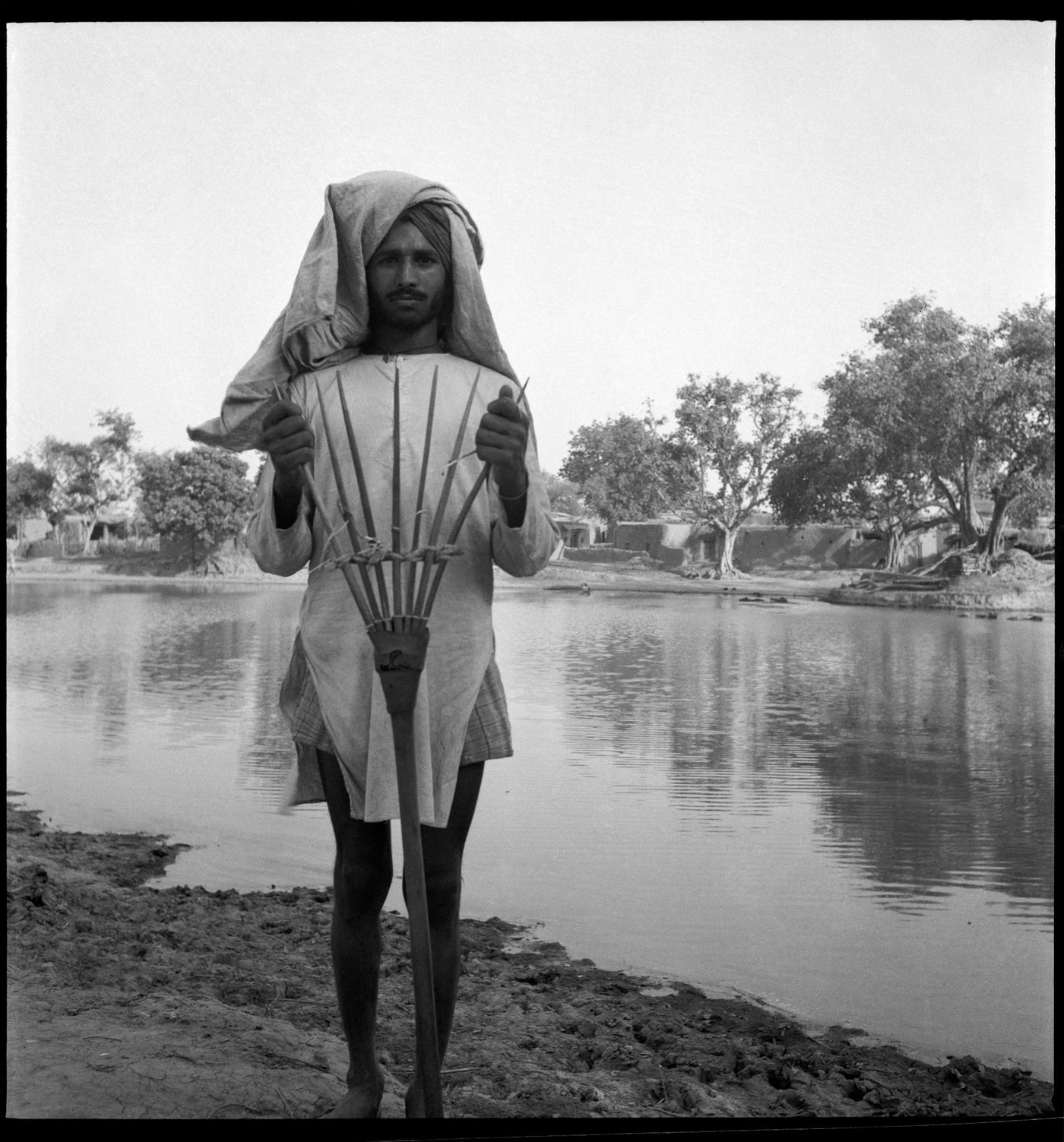 Unidentified man in front of a lake