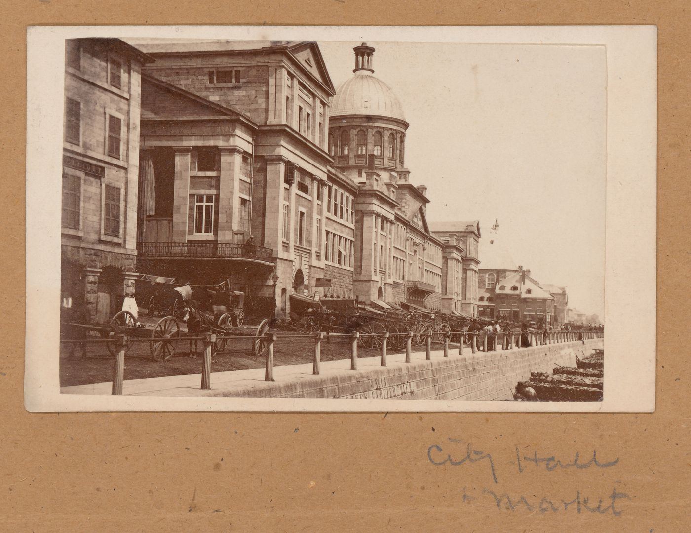 View of the south façade of Marché Bonsecours with horse-drawn vehicles and the Jacques Cartier Pier in the foreground, and Chapelle Notre-Dame-de-Bon-Secours in the background, Montréal, Canada (now Montréal, Québec, Canada)