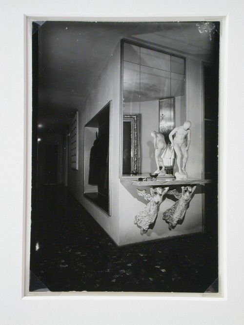 Interior view of Casa Ada and Cesare Minola showing the entrance hall with a mirror and a male nude sculpture standing on a shelf supported by two caryatids, Turin, Italy
