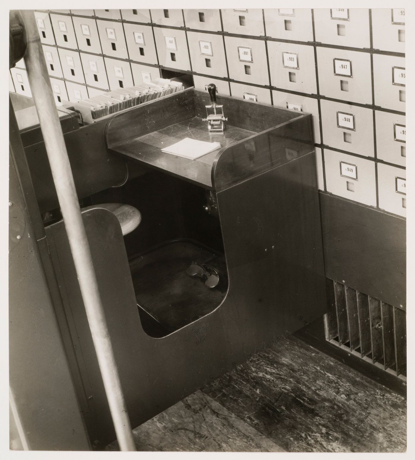 Interior view of the Central Social Insurance Institution showing a close-up view of a mobile work station used to access the card catalog drawers, Prague, Czechoslovakia (now Czech Republic)