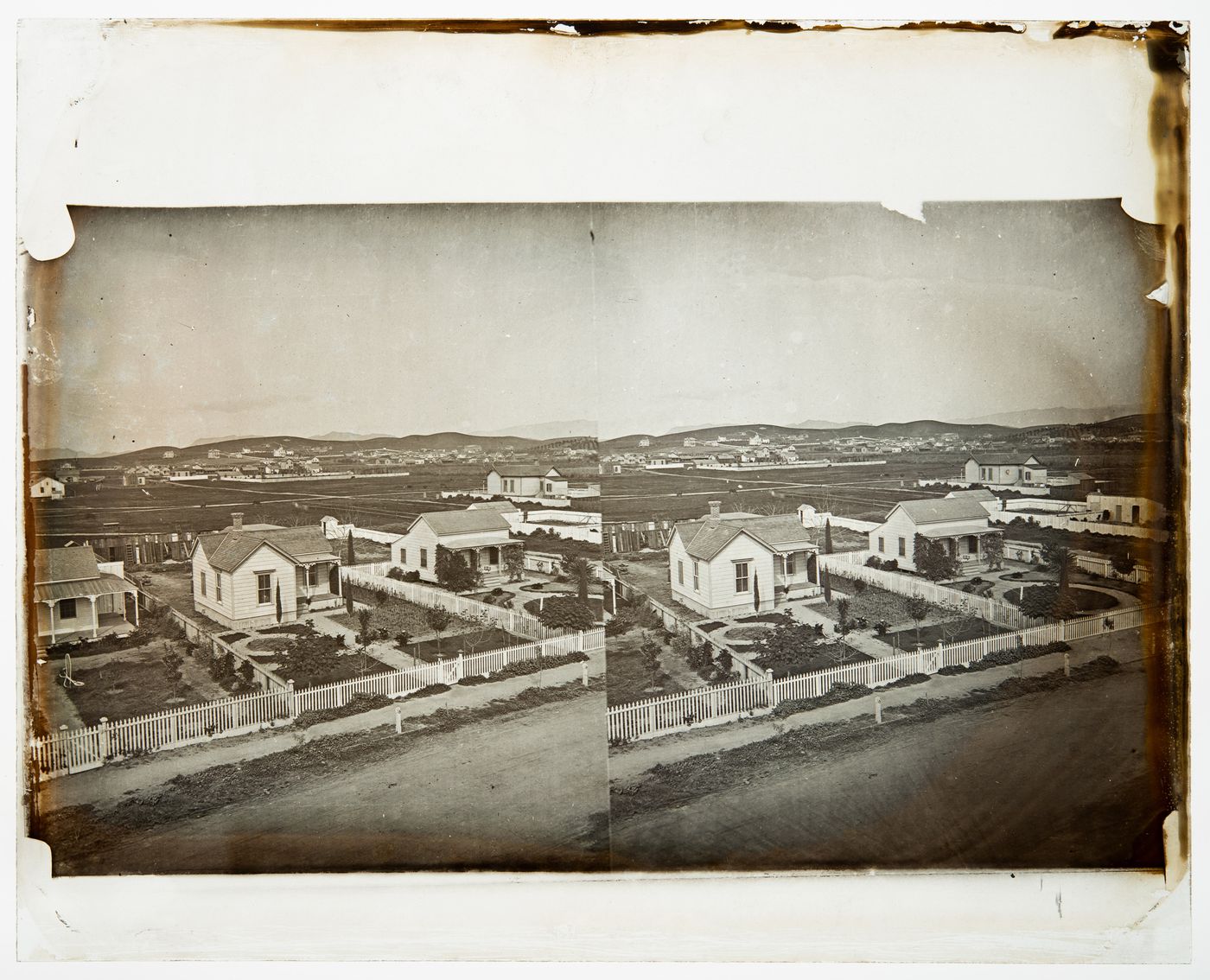 Stereograph of homes with white picket fences, California, United States of America