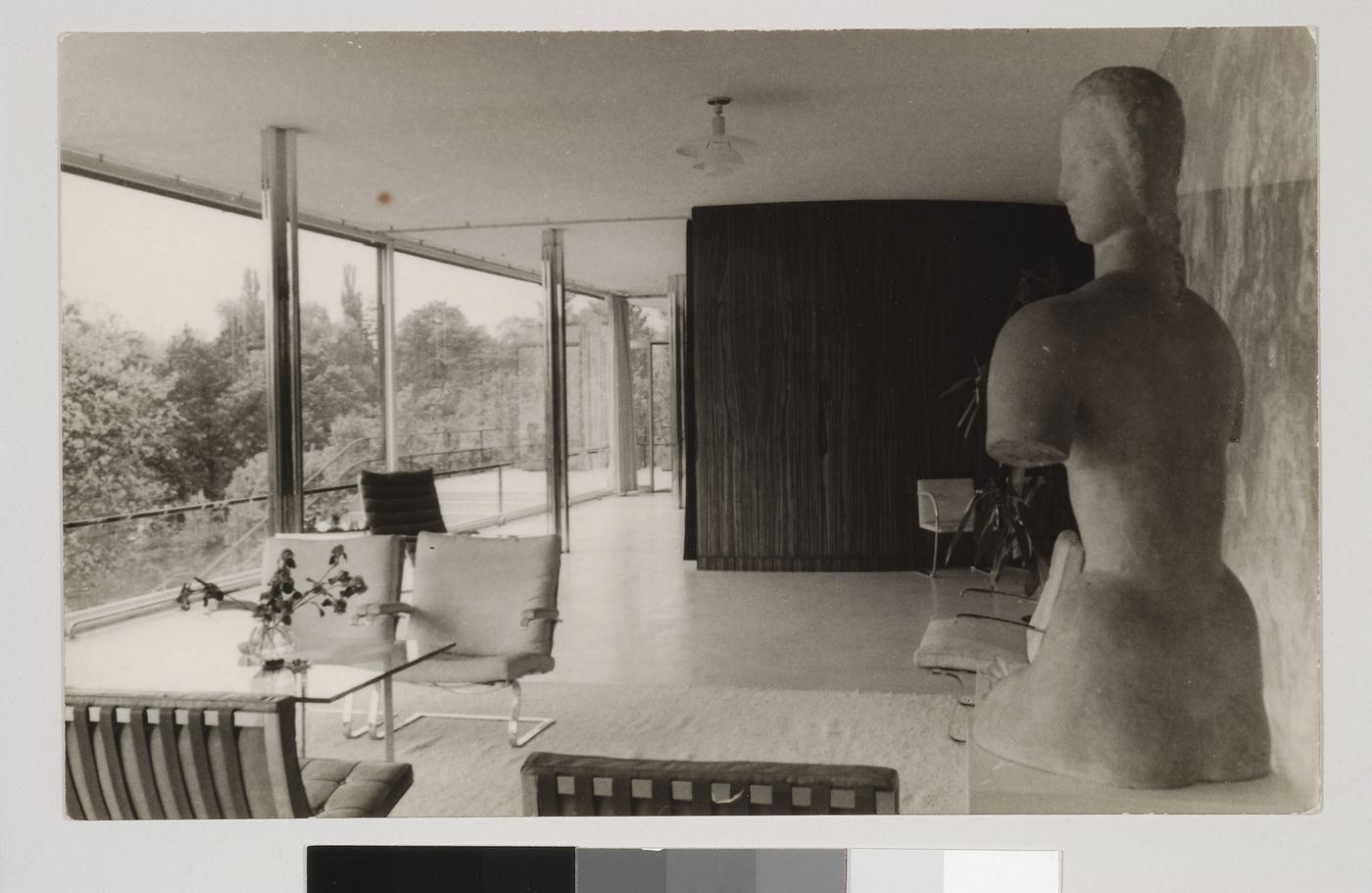 Interior view of the living area looking west showing a seating area on the left and a statue on the right, Tugendhat House, Brno, Czechoslovakia (now Czech Republic)