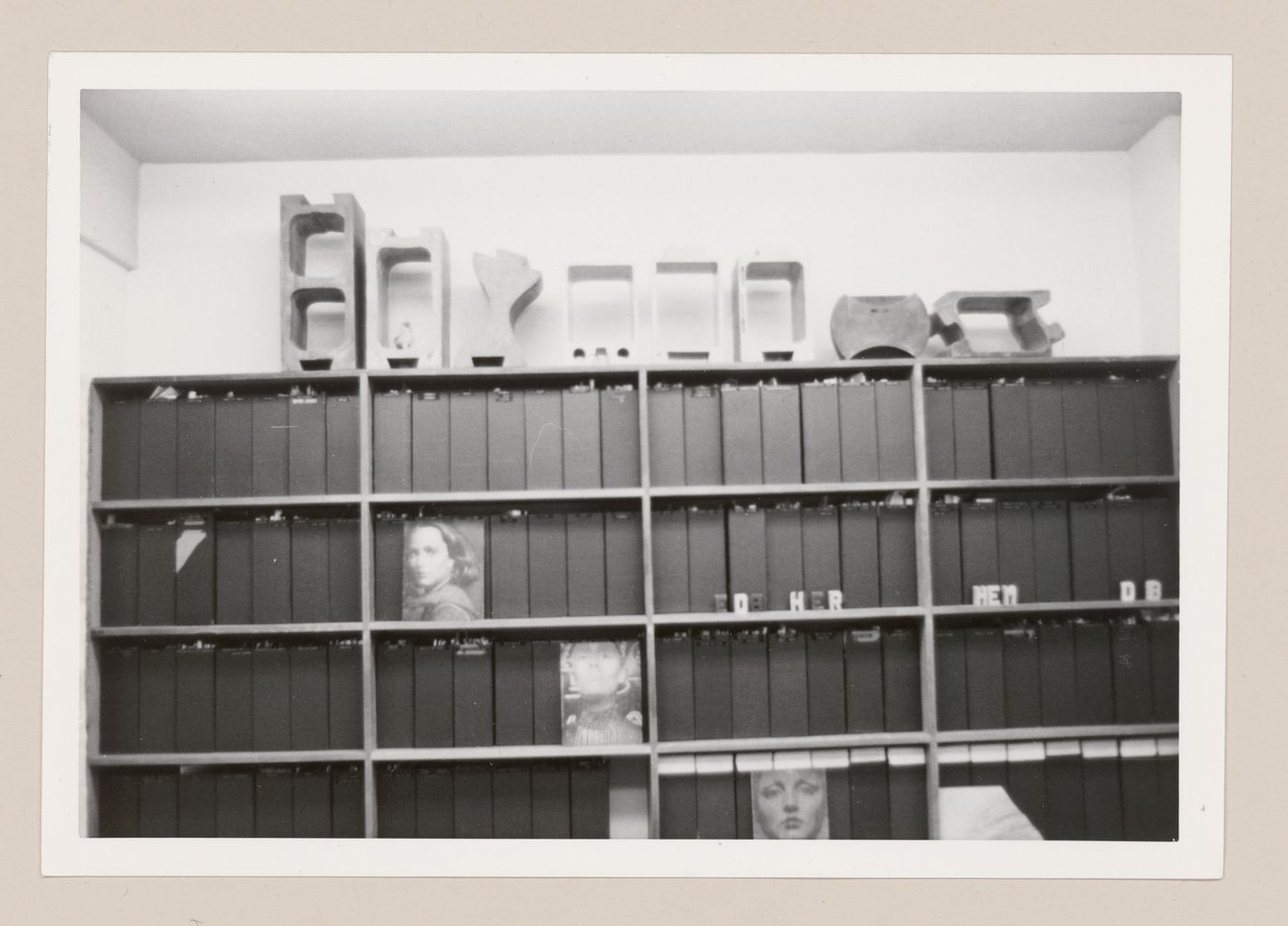 View of bookshelf with sulphur concrete blocks on top