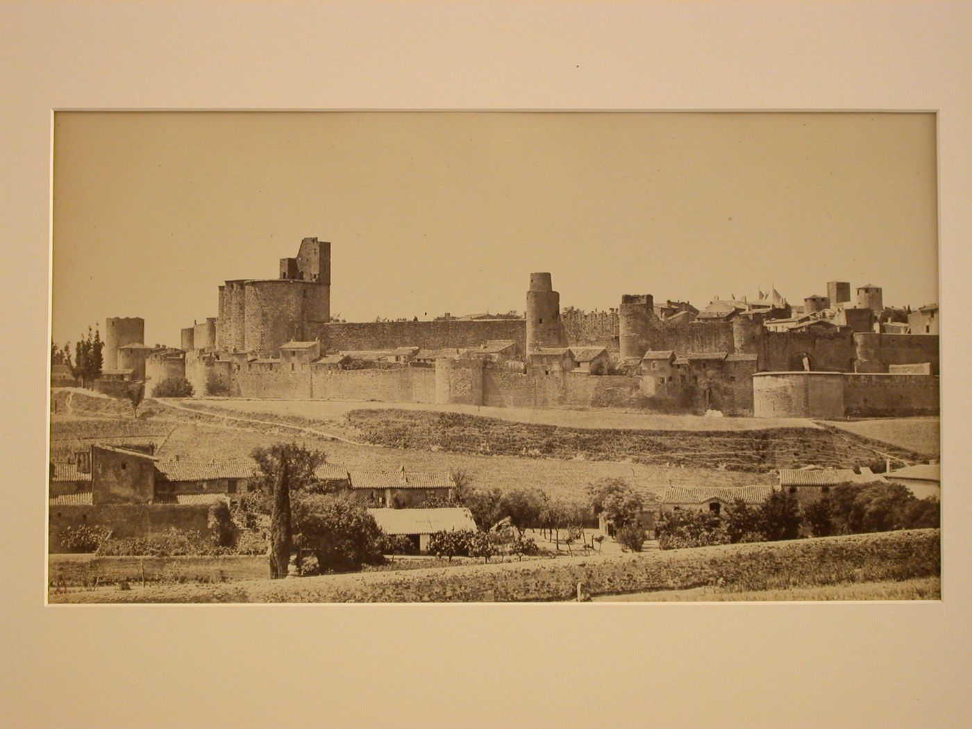 General view from the southwest of ramparts of city, with farm buildings in the foreground, Carcassone, France