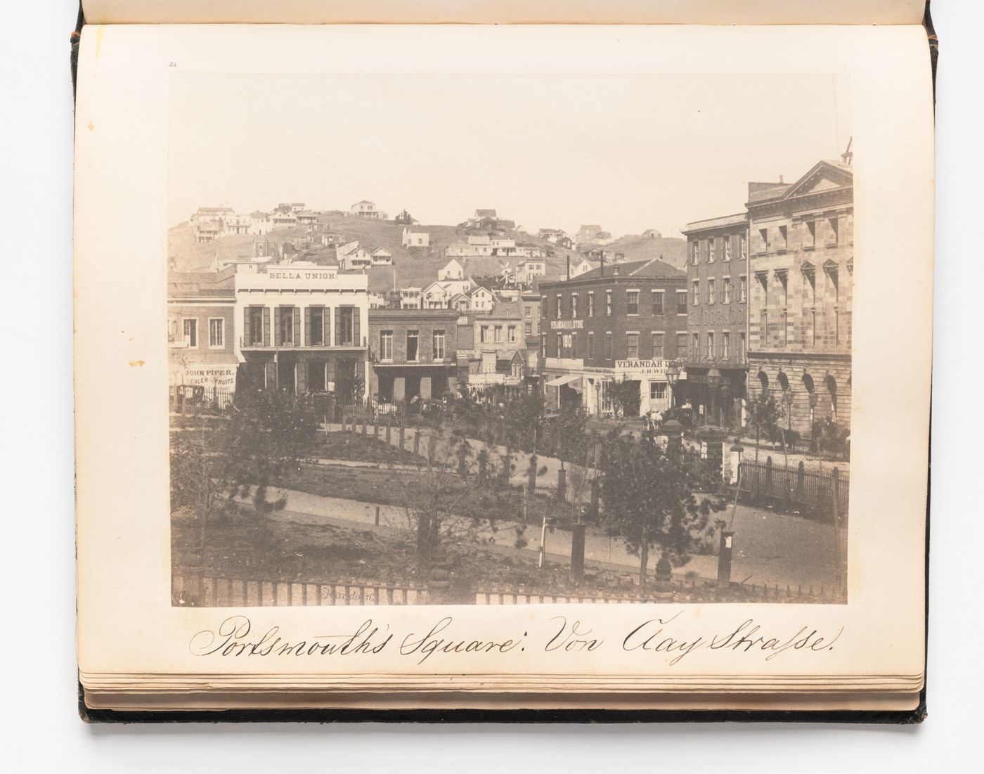 View of stores on Portsmouth Square (also known as the Plaza), Washington and Kearny Streets, San Francisco