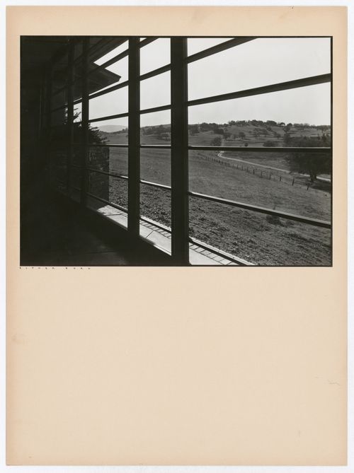 View of the grounds of the Hanna House looking through a window and showing the interior of the house in the foreground, Palo Alto, California, United States