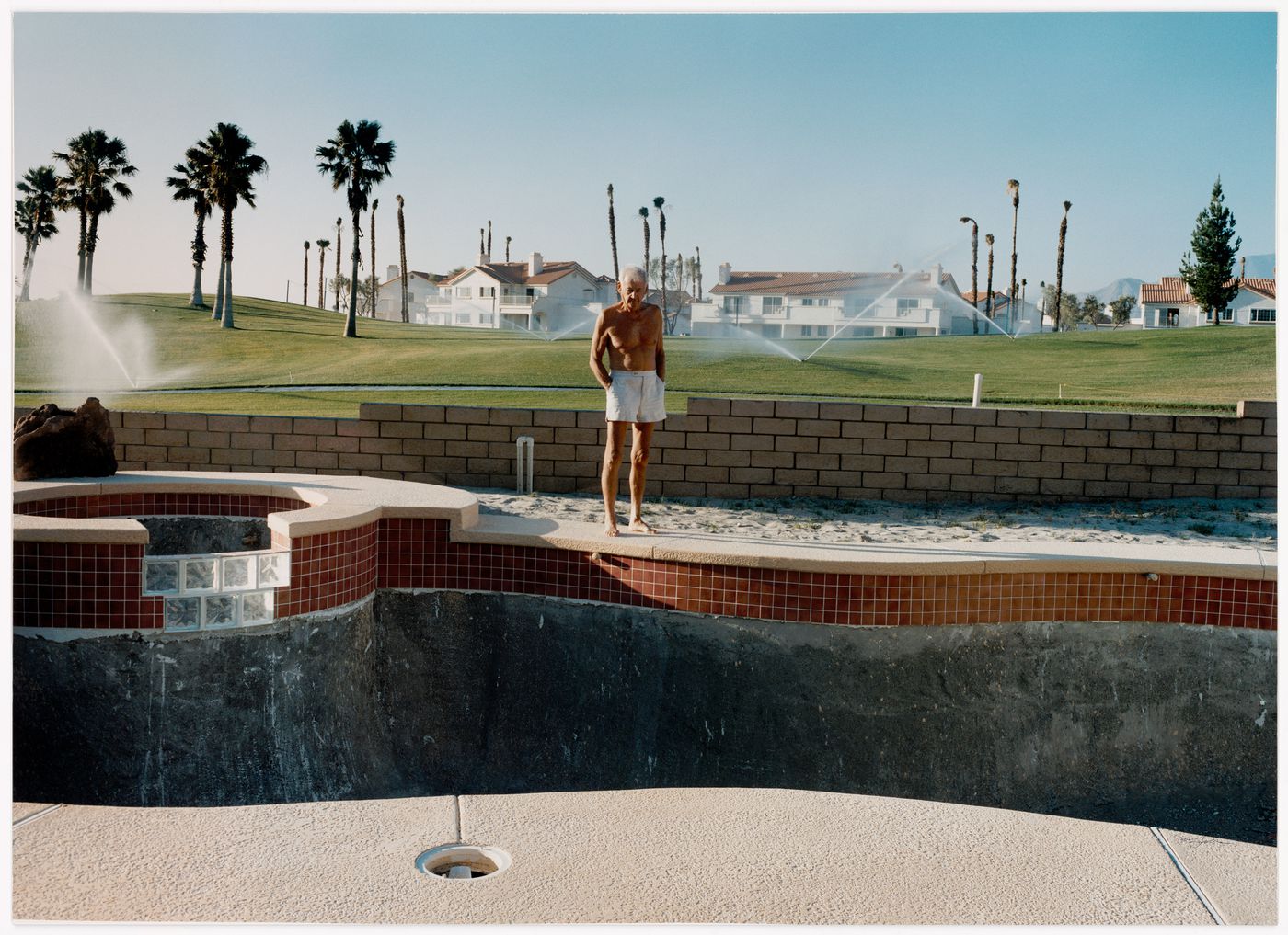 Untitled from the series Pictures from Home, (Dad looking into empty pool)