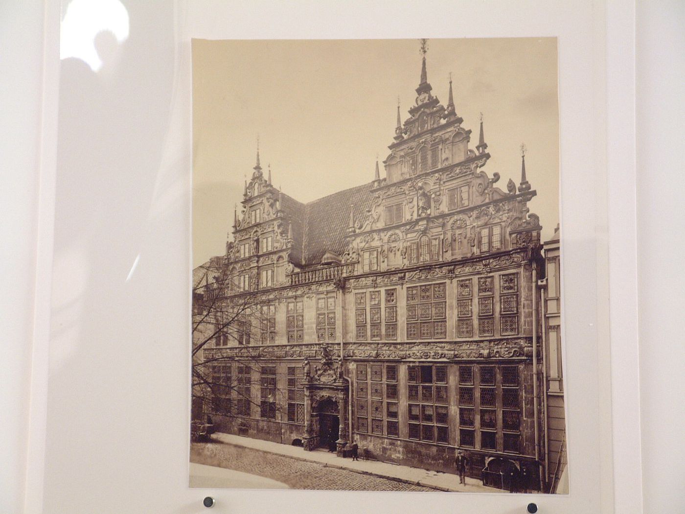 View of façade of highly ornate 5 storey, gabled house facing cobblestoned street, Germany ?