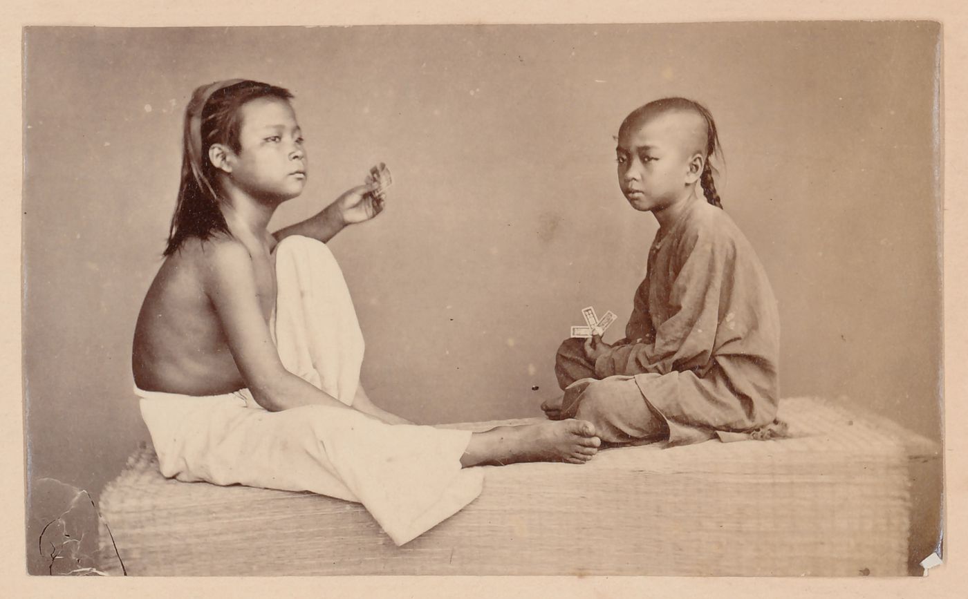 Group portrait of two boys with playing cards, probably in Cochin China (now in Vietnam)