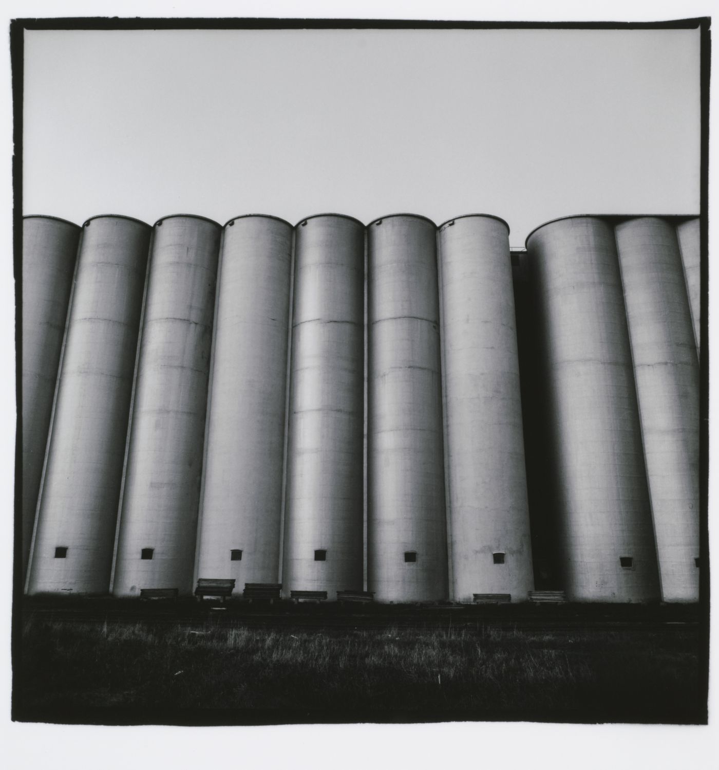 Wide-angle view of tall, tube-shaped grain elevators, Minneapolis, Minnesota