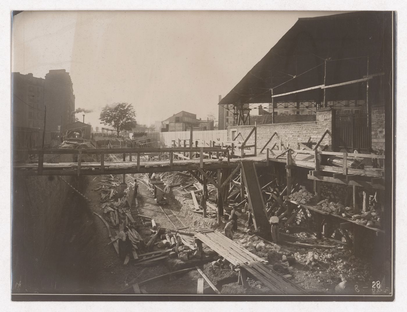 Construction of the Paris Metro, exterior construction view of wooden bridge over work area, Paris, France