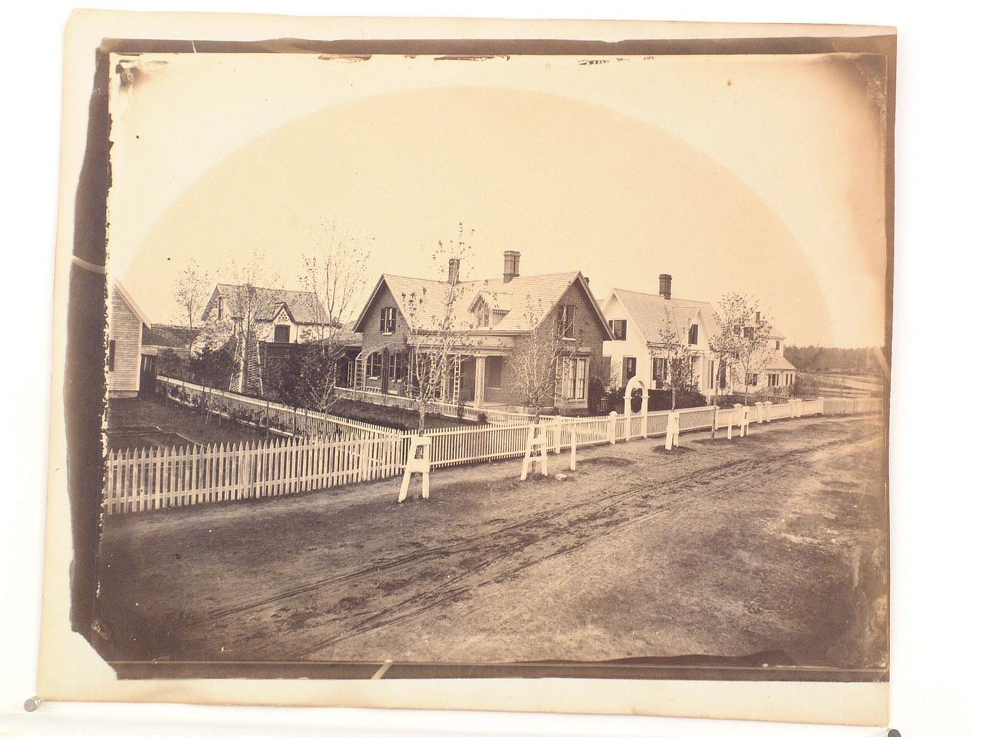 Street with fenced-off houses in a row