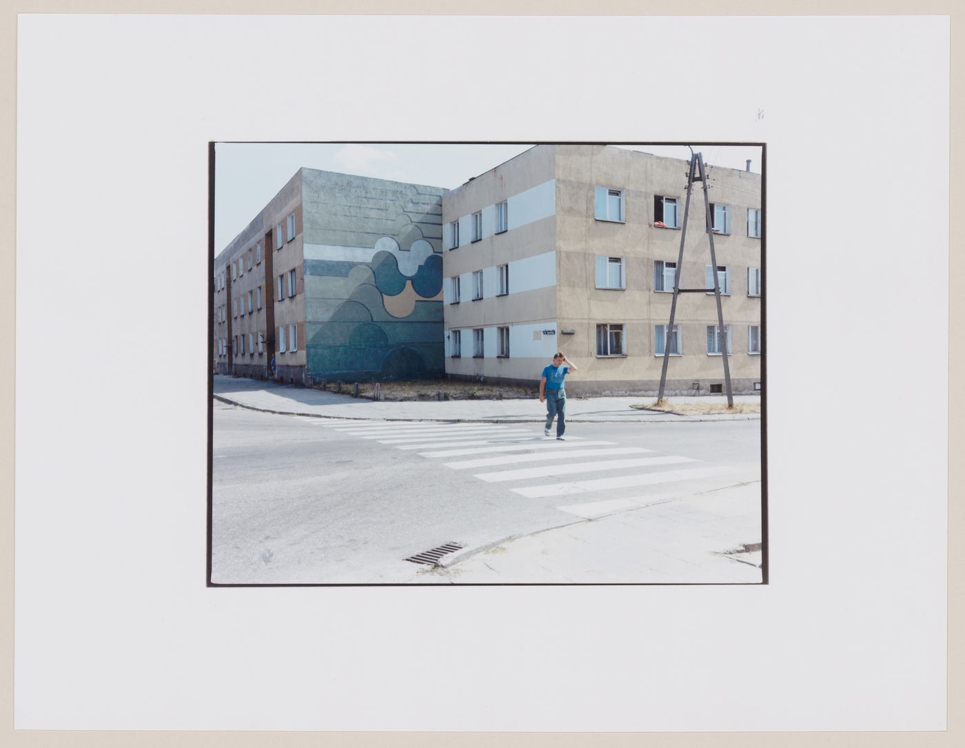 View of apartment houses and a man crossing a street, Gorzów Wielkopolski, Poland (from the series "In between cities")