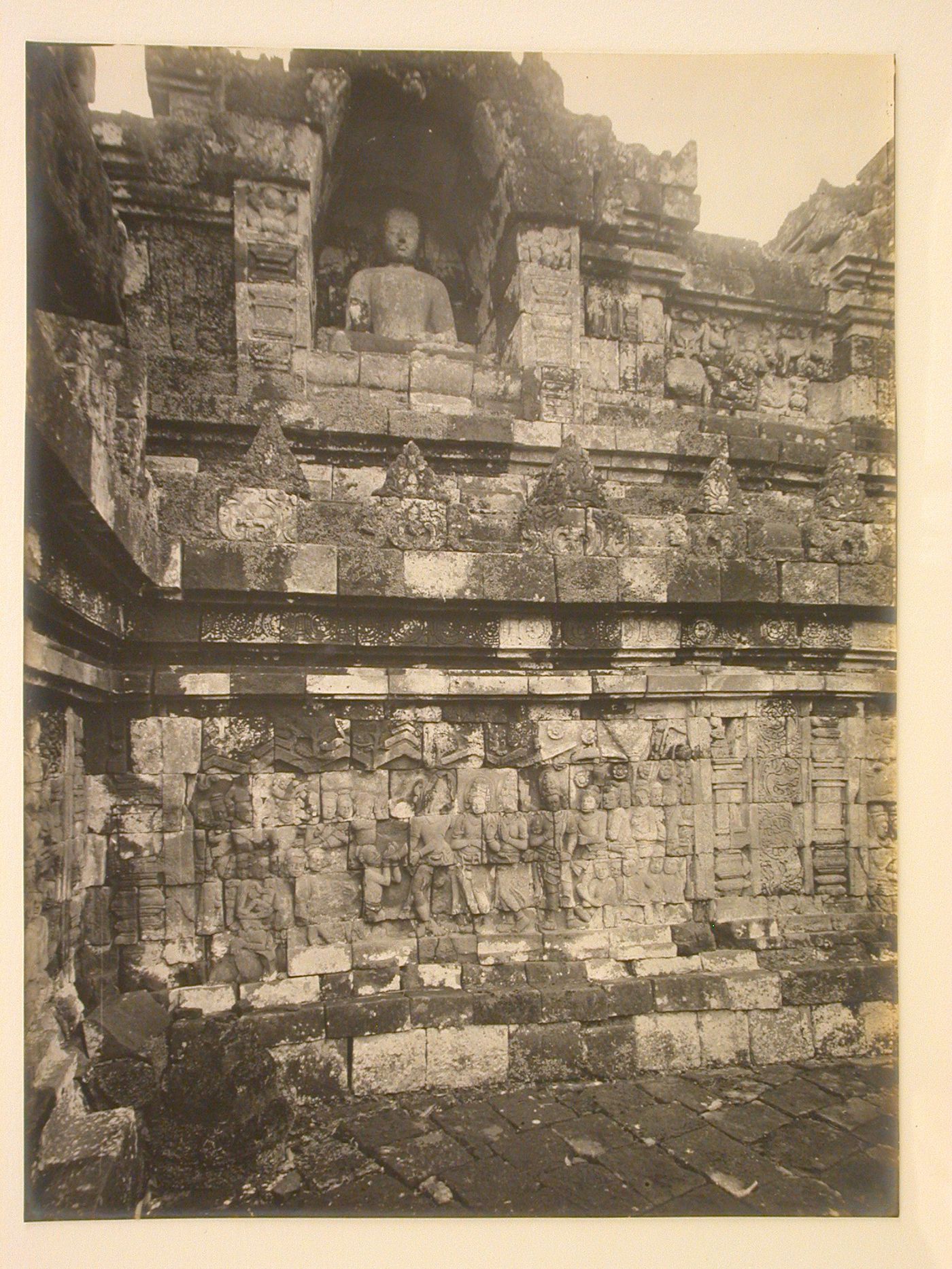 Close-up view of the temple of Borobudur showing relief panels and a statue of the Buddha in a niche, Borobudur, Indonesia