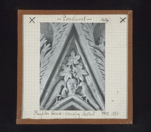 Detail view of canopy with foliate mask and two birds on tympanum in Chapter House, Southwell Minster, Southwell, Nottinghamshire, England
