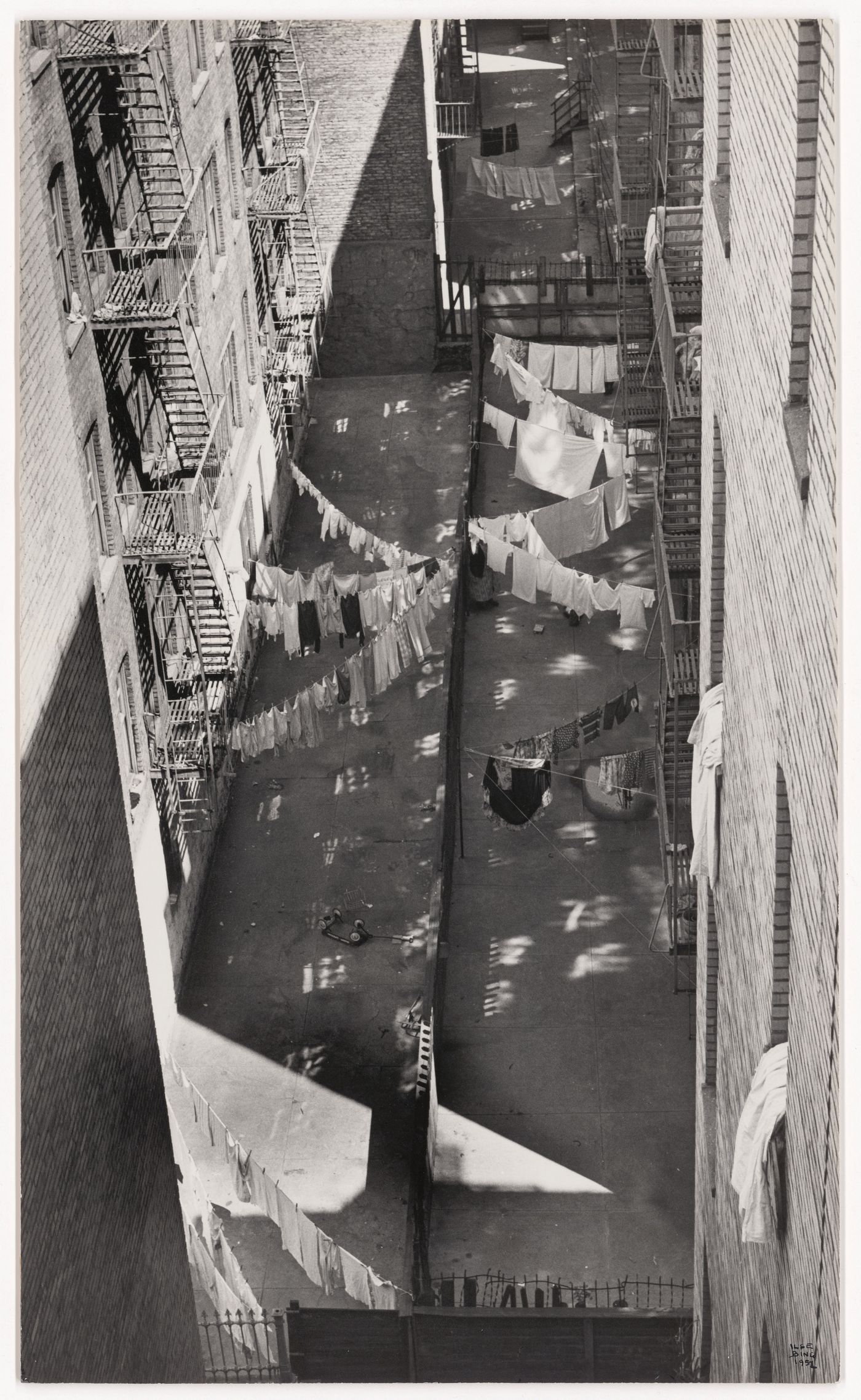 Looking down at hanging laundry lines criss-crossing the courtyard, New York City, New York